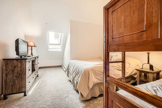 a living room with a bed furniture and a window