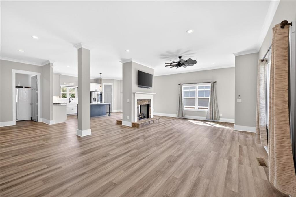5118 Floyd Street Northeast Covington, GA 30014 - Photo 13 of 78 a view of a livingroom with wooden floor and a ceiling fan