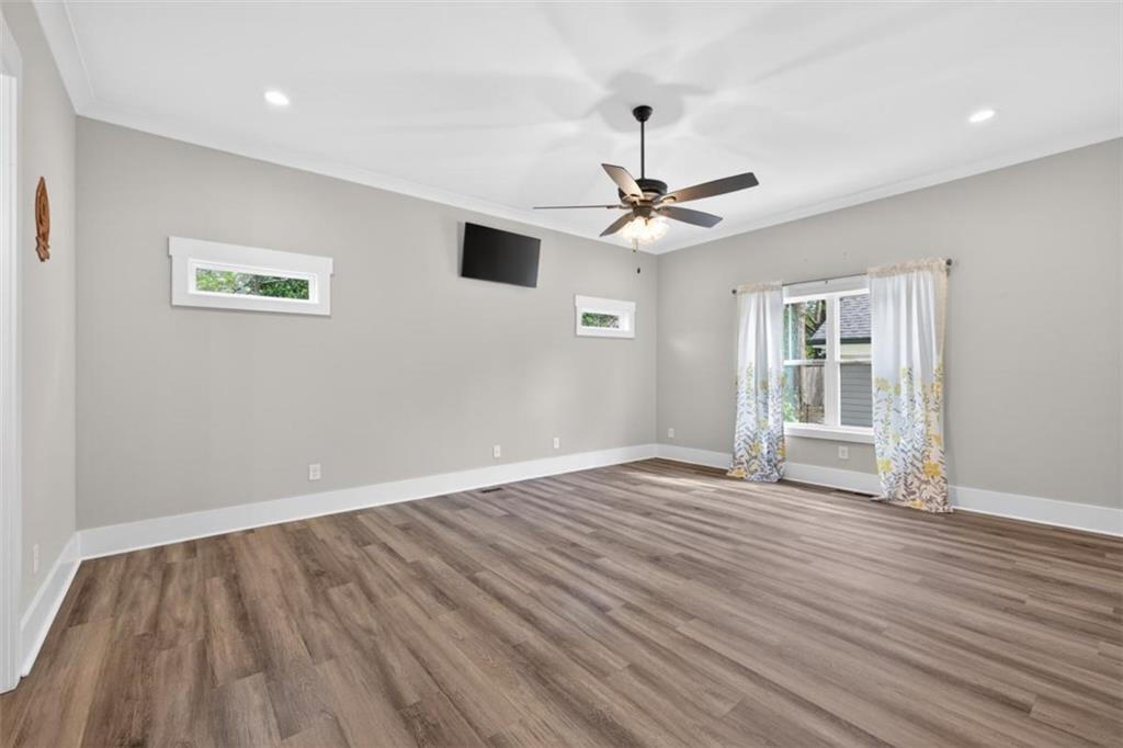 5118 Floyd Street Northeast Covington, GA 30014 - Photo 26 of 78 a view of an empty room with wooden floor and a ceiling fan