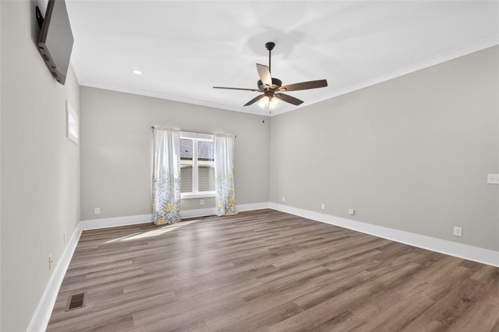 5118 Floyd Street Northeast Covington, GA 30014 - Photo 28 of 78 a view of an empty room with wooden floor and a window