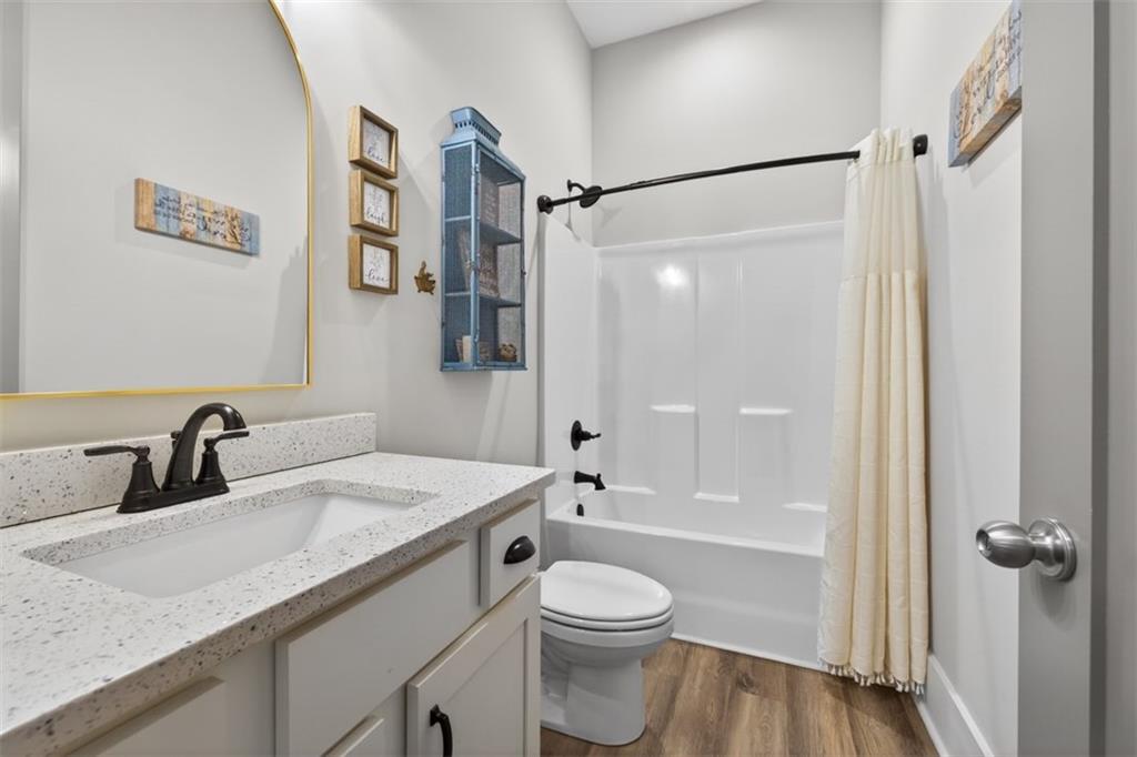 5118 Floyd Street Northeast Covington, GA 30014 - Photo 39 of 78 a bathroom with a granite countertop sink toilet and shower