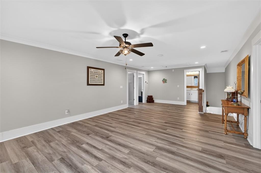 5118 Floyd Street Northeast Covington, GA 30014 - Photo 40 of 78 a view of empty room with wooden floor and fan