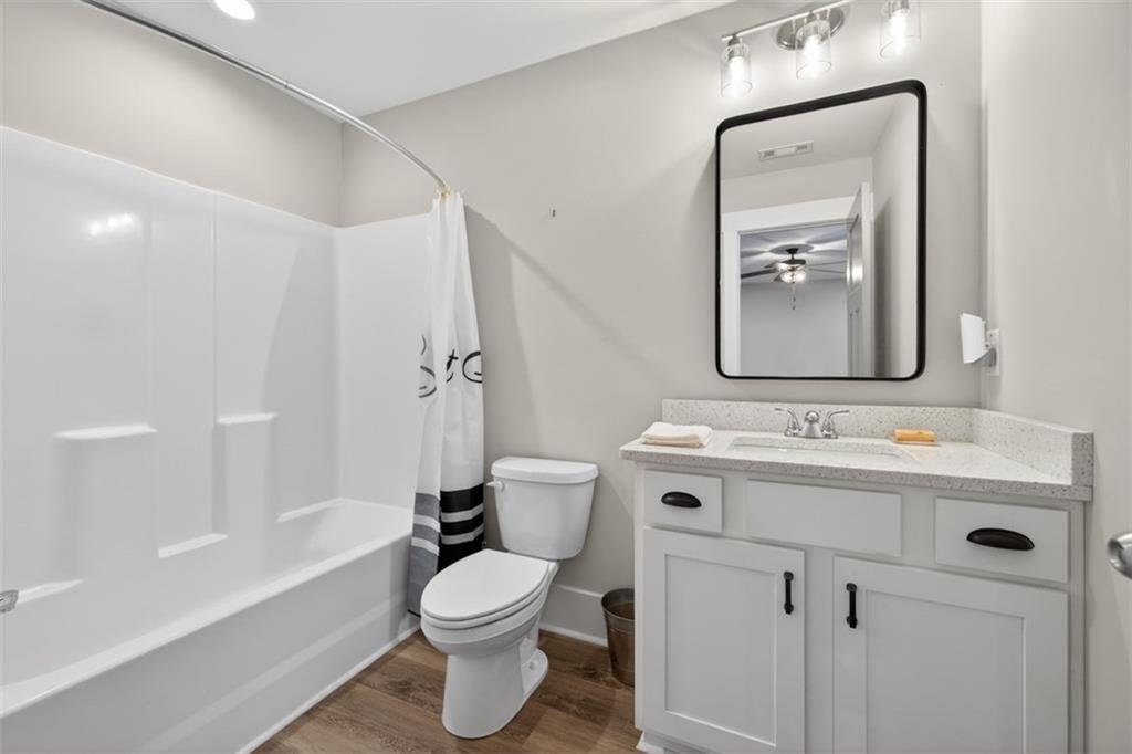 5118 Floyd Street Northeast Covington, GA 30014 - Photo 52 of 78 a bathroom with a toilet sink and mirror