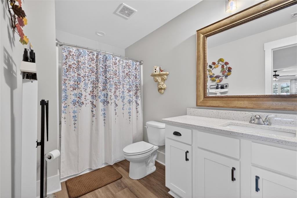 5118 Floyd Street Northeast Covington, GA 30014 - Photo 54 of 78 a bathroom with a sink a toilet and a shower curtain