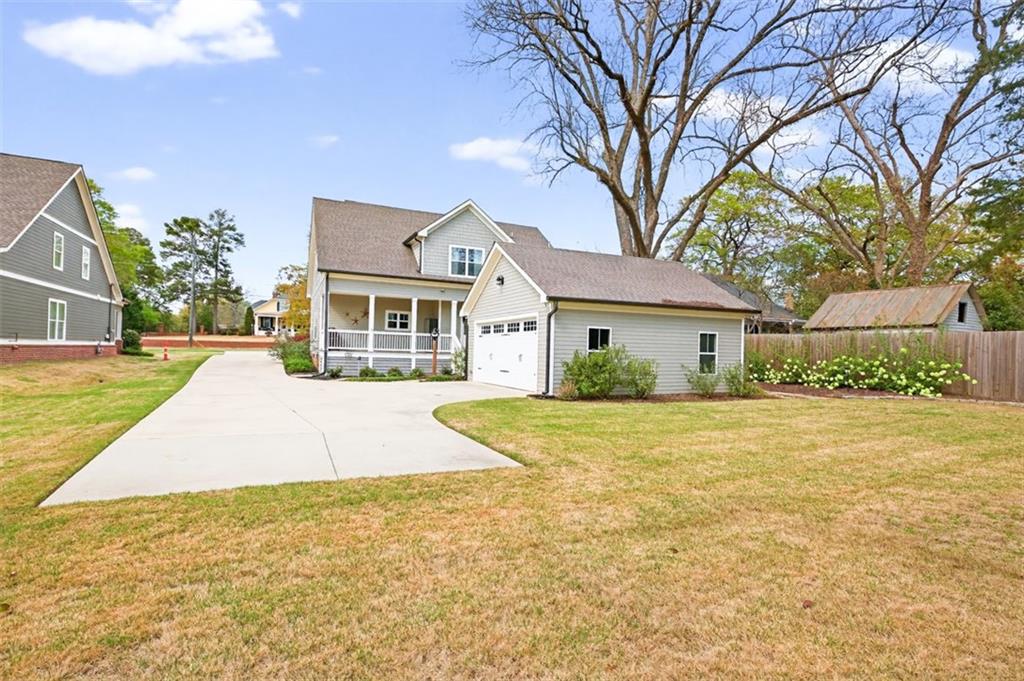 5118 Floyd Street Northeast Covington, GA 30014 - Photo 62 of 78 a front view of a house with a yard and garage
