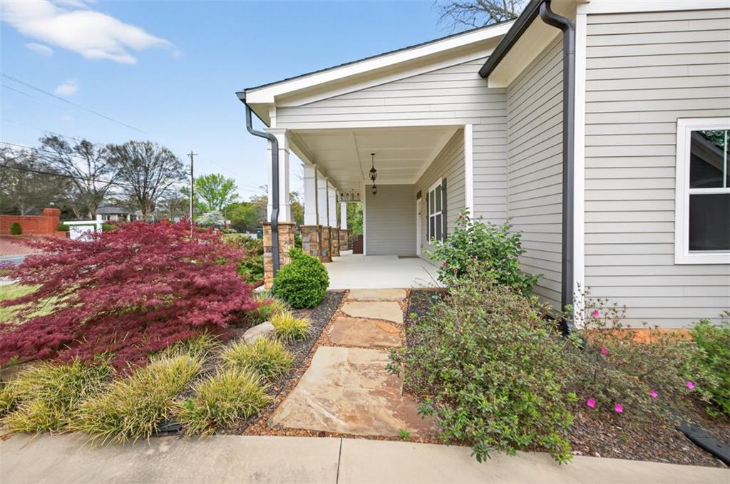 5118 Floyd Street Northeast Covington, GA 30014 - Photo 70 of 78 a view of a house with a small yard and flower plants