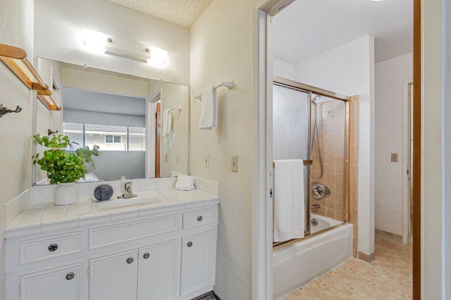 844-846 Doyle Road San Jose, CA 95129 - Photo 32 of 38 a bathroom with a shower sink and mirror