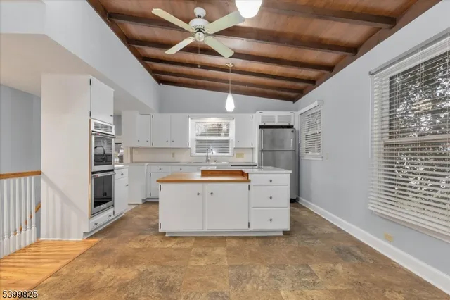 a large white kitchen with cabinets