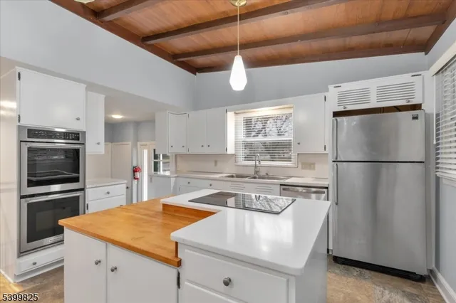a kitchen with a stove a refrigerator and a sink