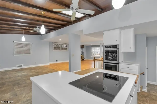 a kitchen with stainless steel appliances granite countertop a sink a stove and a refrigerator