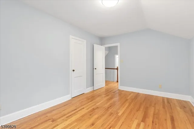 a view of an empty room and wooden floor