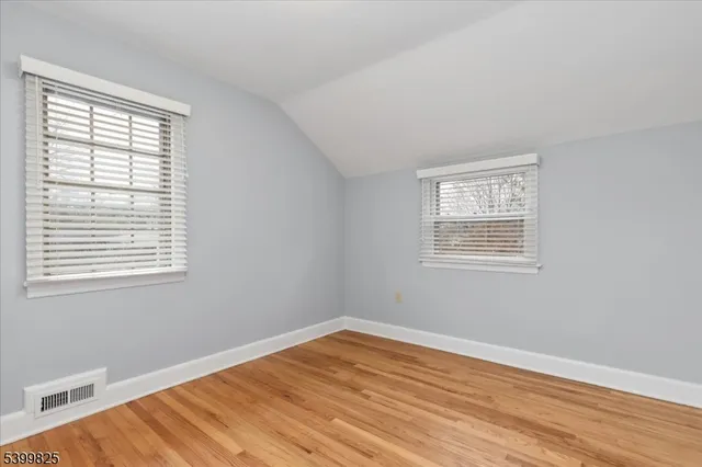 a view of a room with a wooden floor and a window
