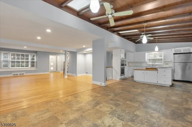 a view of an empty room with a kitchen