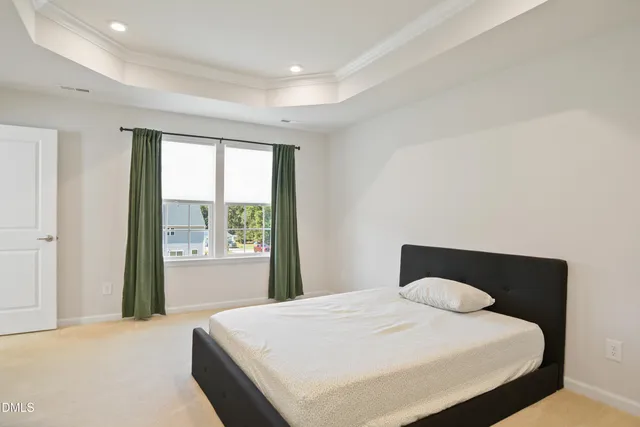 a bedroom with a bed and a painting