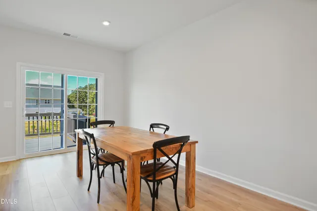 a large kitchen with kitchen island a sink table and chairs