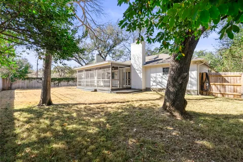 a view of a house with snow on a tree