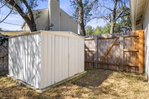 a view of a house with a wooden fence