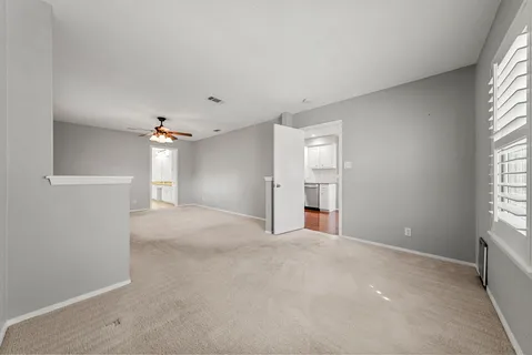 an empty room with windows and closet