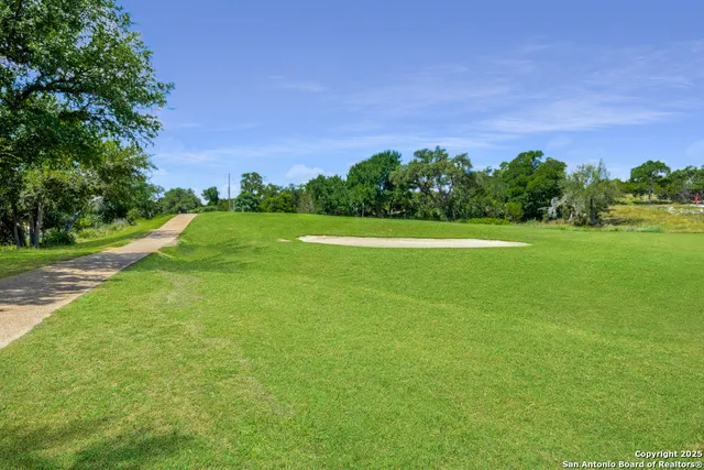 a view of a green field with clear sky