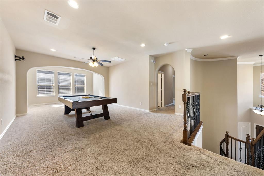 8336 Pitkin Road Frisco, TX 75036 - Photo 20 of 40 a living room with furniture and a chandelier