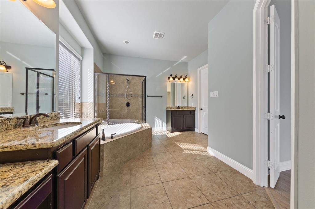 8336 Pitkin Road Frisco, TX 75036 - Photo 24 of 40 a spacious bathroom with a granite countertop tub sink and mirror
