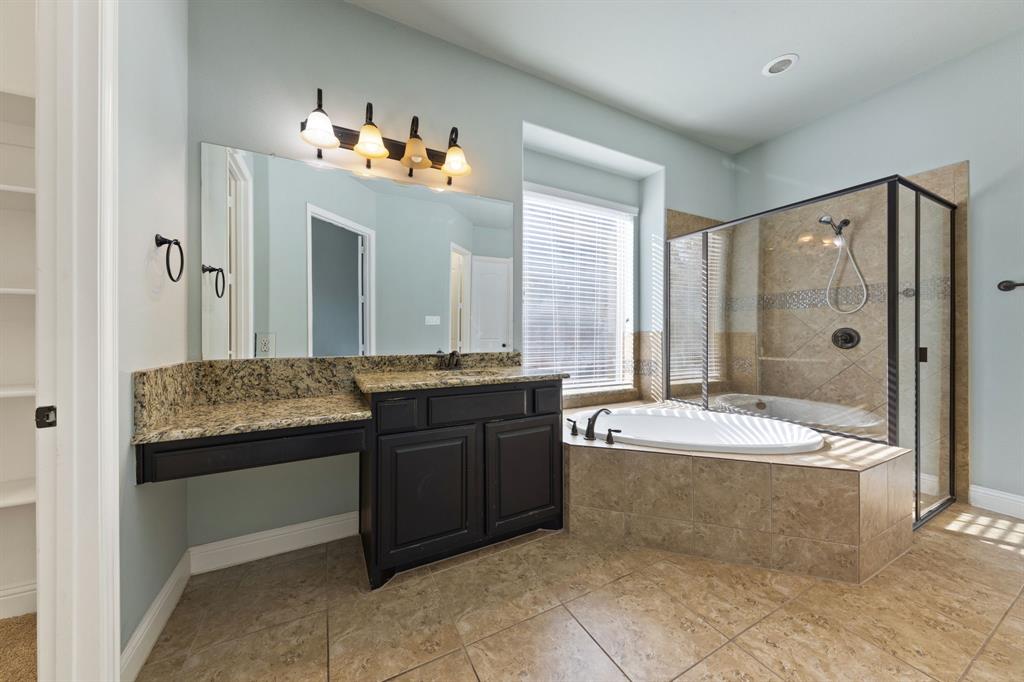 8336 Pitkin Road Frisco, TX 75036 - Photo 25 of 40 a spacious bathroom with a bathtub sink and mirror