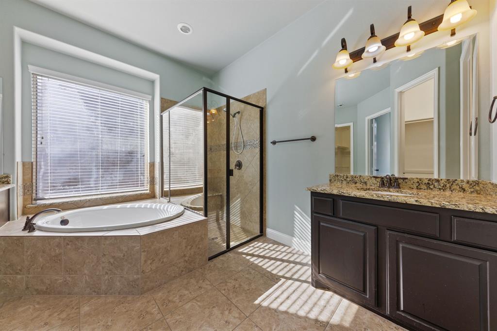 8336 Pitkin Road Frisco, TX 75036 - Photo 27 of 40 a spacious bathroom with a granite countertop tub sink and mirror