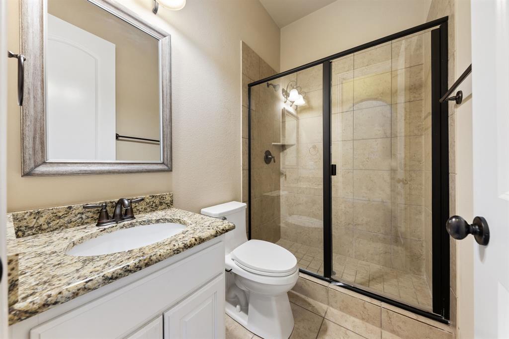 8336 Pitkin Road Frisco, TX 75036 - Photo 30 of 40 a bathroom with a granite countertop sink toilet and shower