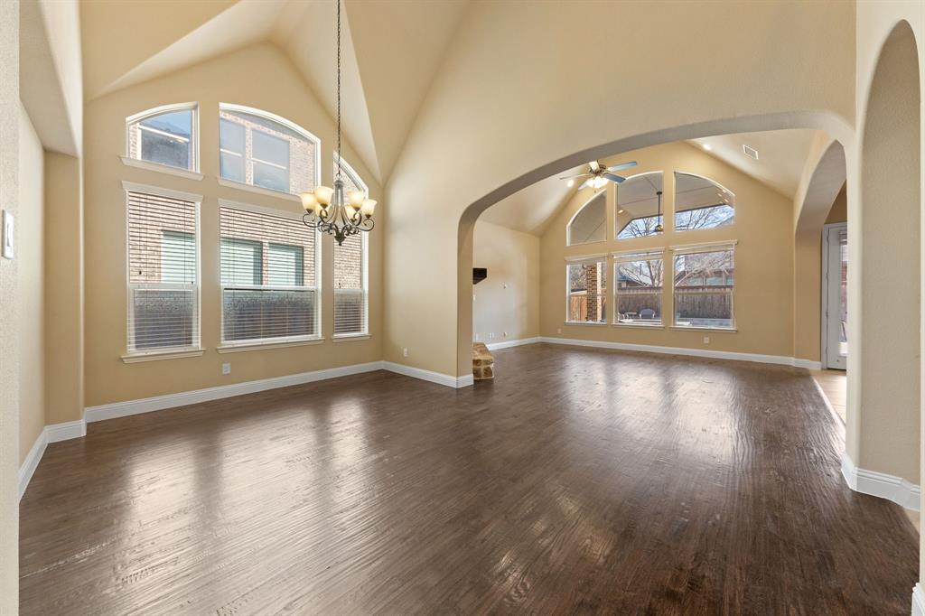 8336 Pitkin Road Frisco, TX 75036 - Photo 8 of 40 a view of a big room with wooden floor a glass table and windows