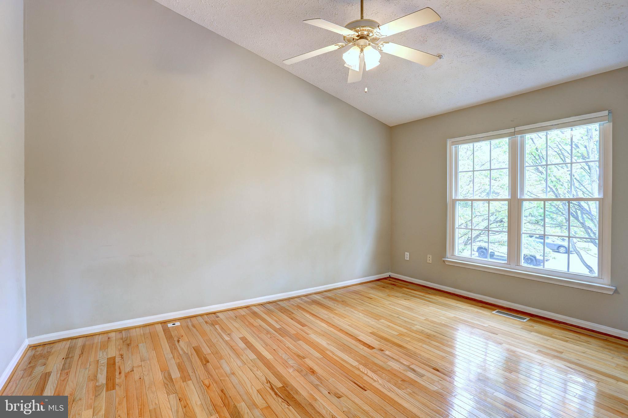 6136 Starburn Path Columbia, MD 21045 - Photo 14 of 35 wooden floor in an empty room with a window