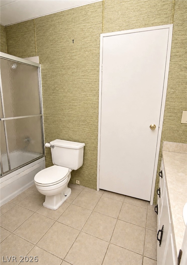 4556 Royal Ridge Way Las Vegas, NV 89103 - Photo 22 of 49 A classic tub and shower combination anchors this tiled bathroom layout.
