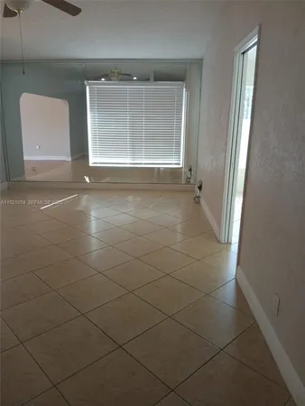 a view of a livingroom with an empty space and a window