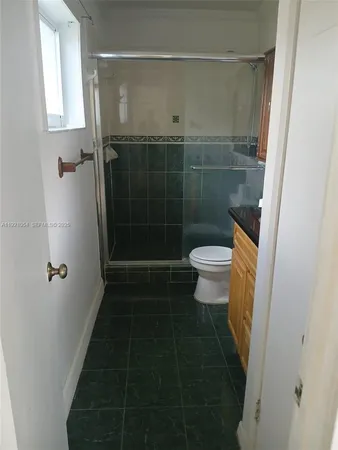 a bathroom with a toilet and a shower