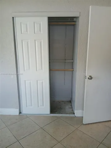 a bathroom with a granite countertop sink a mirror and vanity