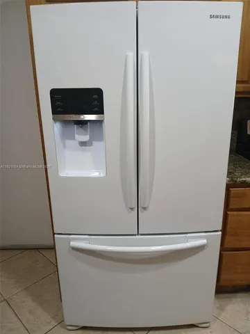 a view of a hallway and a kitchen