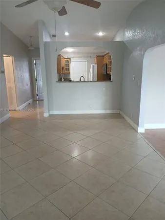 a view of a hallway and a kitchen