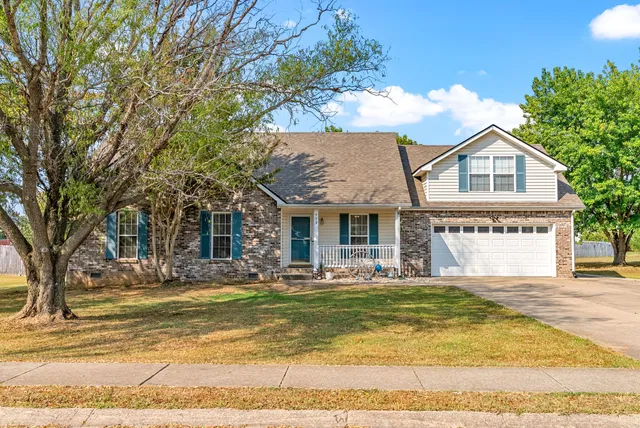 a front view of house with yard and trees around
