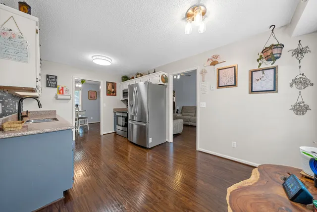 a view of kitchen and windows with wooden floor