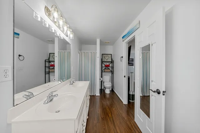 a bathroom with a bathtub and a double vanity sink