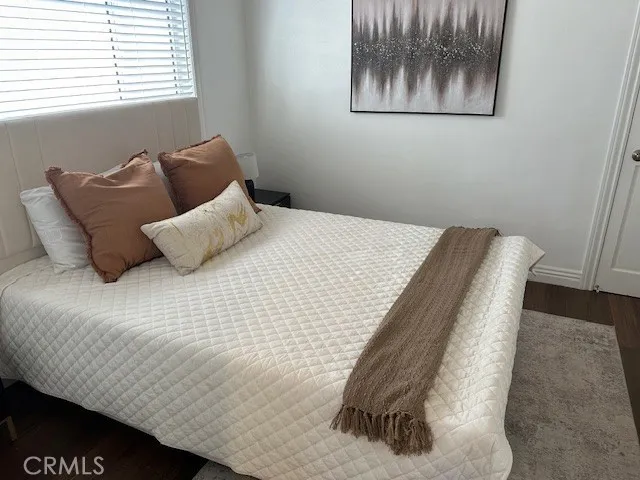 a bedroom with a bed and wall painting