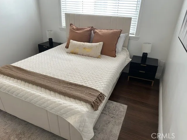 a bedroom with a bed and a night stand