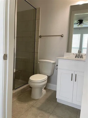 a white toilet sitting next to a bathroom sink