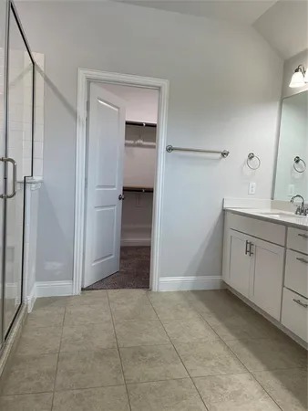 a view of a kitchen with white cabinets