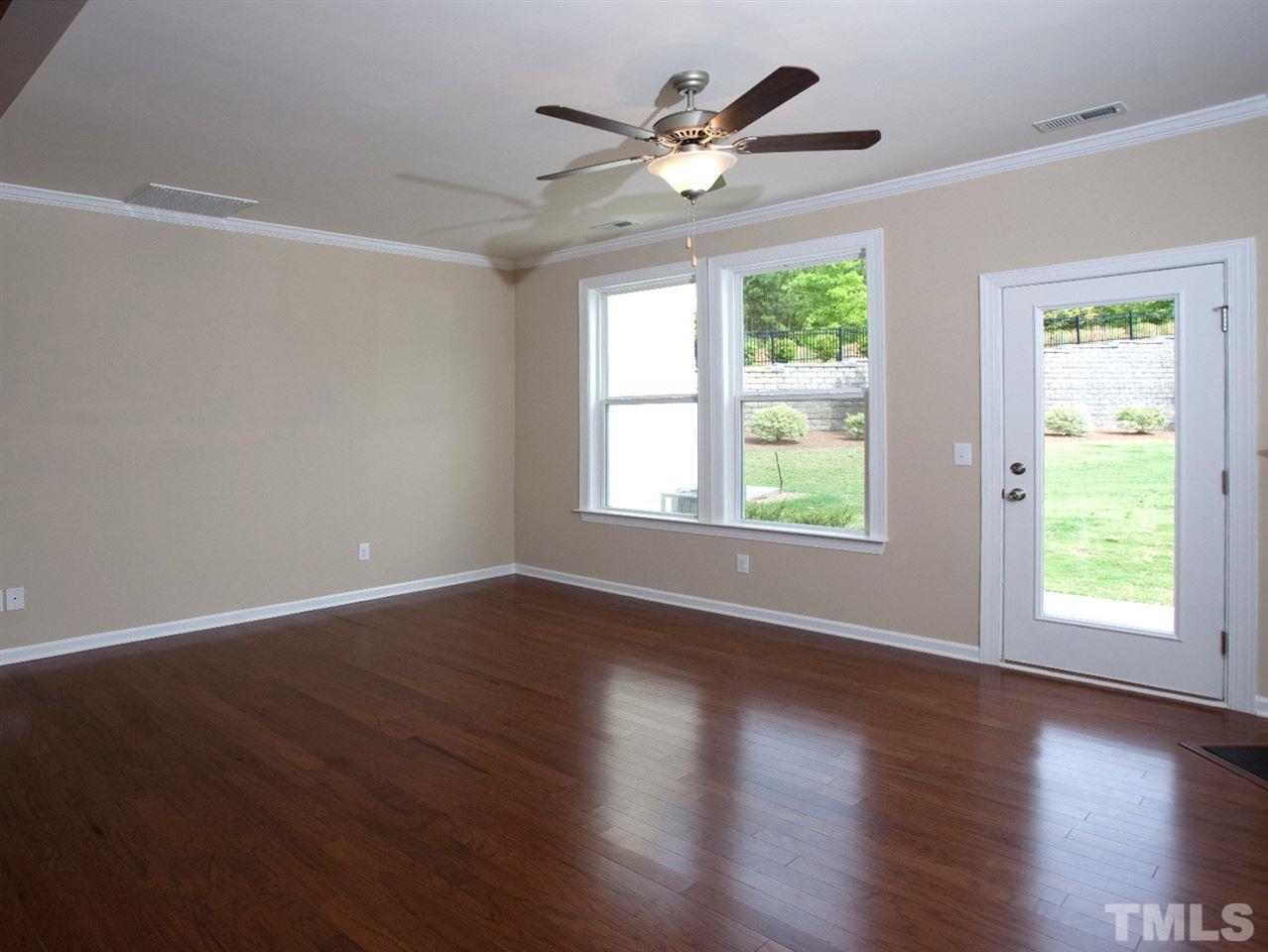 213 Irving Way, Unit 69 Durham, NC 27703 - Photo 8 of 25 a view of an empty room with wooden floor and a window