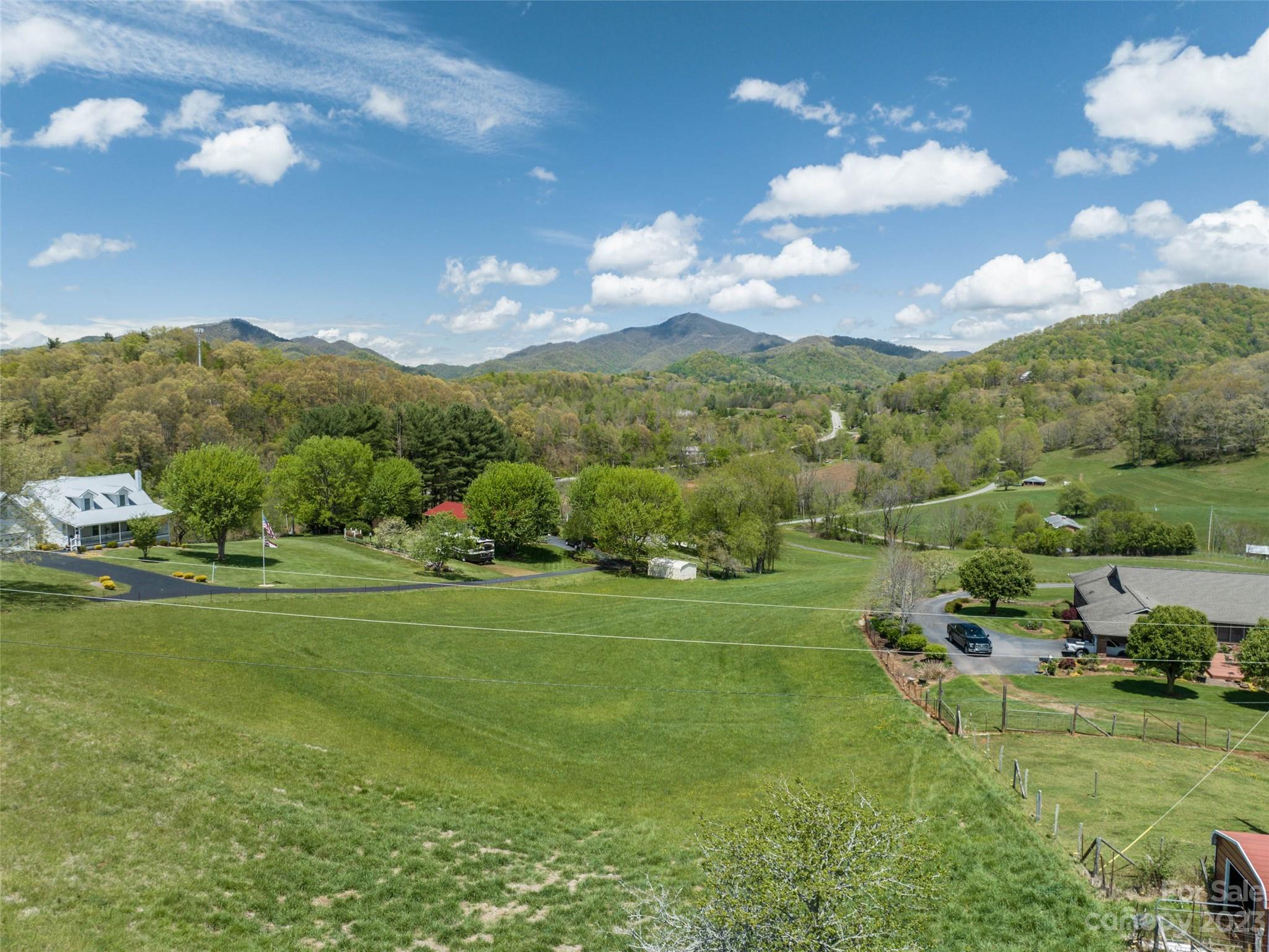 4 Sunny Hill Lane Clyde, NC 28721 - Photo 23 of 27 a view of a big yard with lawn chairs and large trees