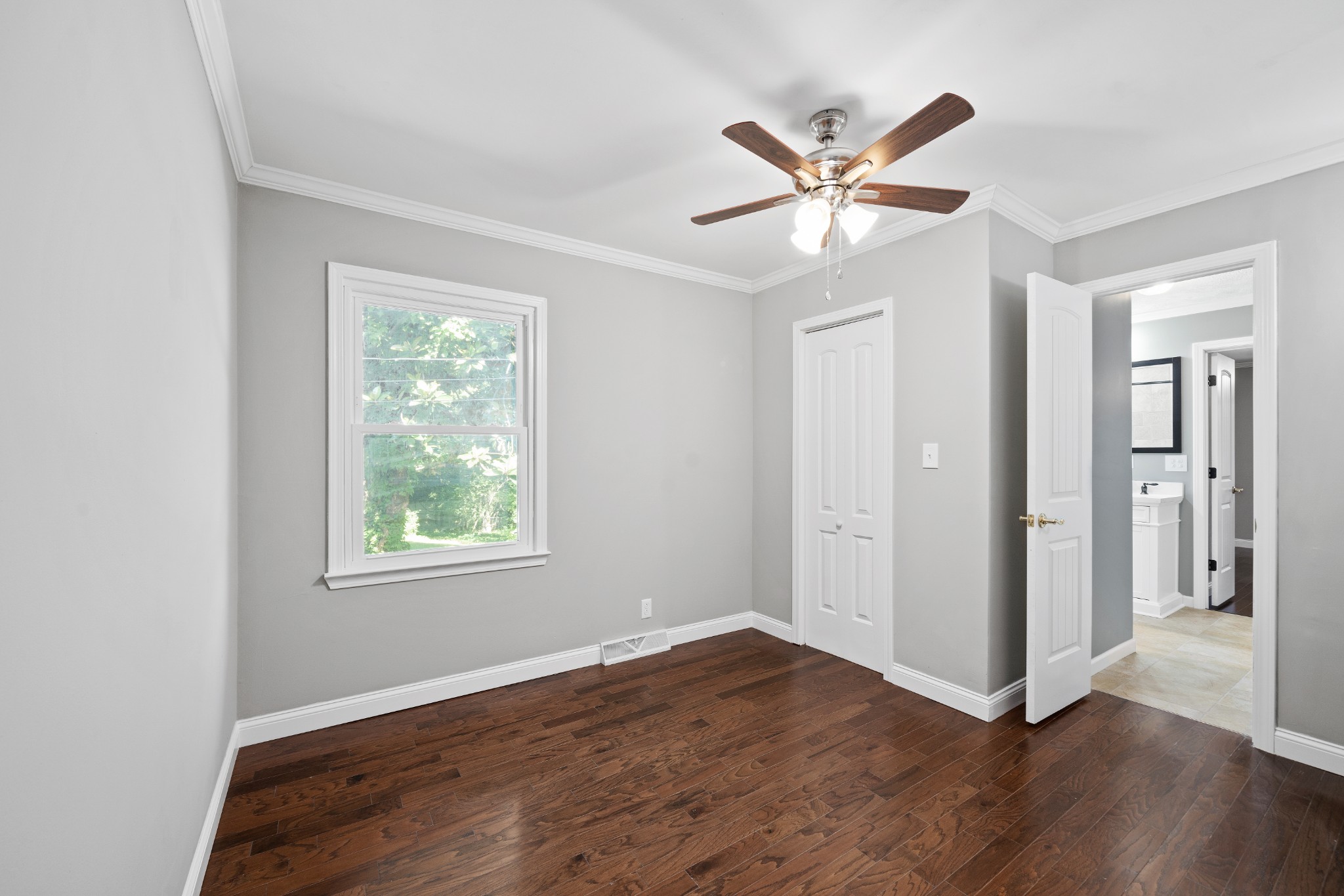 964 Gratton Road Clarksville, TN 37043 - Photo 25 of 43 a view of an empty room with wooden floor and a ceiling fan