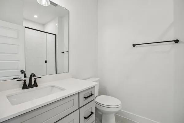 a bathroom with a sink a toilet and a mirror