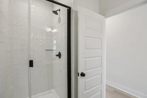 a bathroom with a glass shower door
