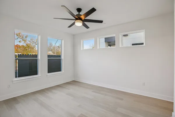 a view of wooden floor and windows in a room