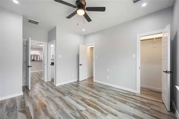 a view of a room with wooden floor and bathroom view